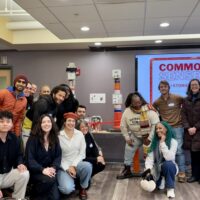 A diverse group of community members gathered for a picture inside a meeting room to celebrate the launch of the Common SENSES Network.
