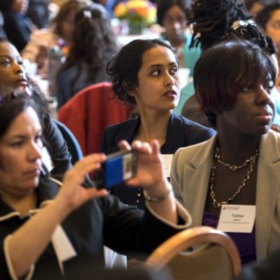 attendees at the women of color in the academy conference listen and take pictures