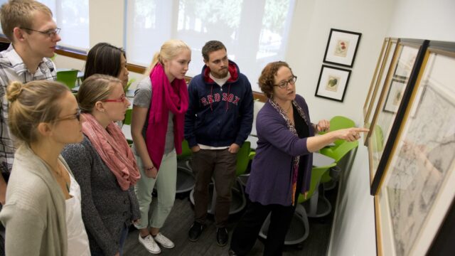 professor marina leslie showing students the arader maps at snell library