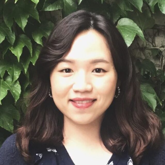 headshot of Joy Kwon in front of a leafy background