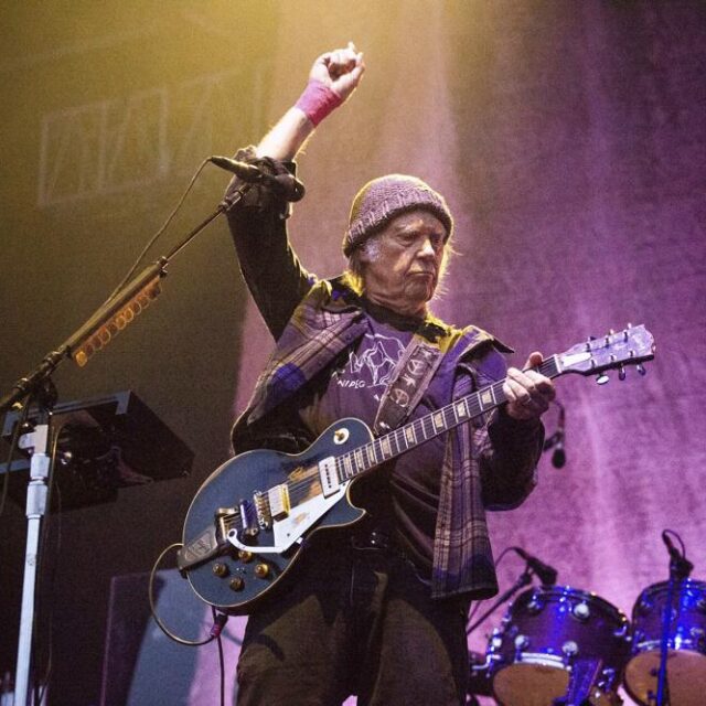 Picture depicts Neil Young performing onstage at the BattleRock Napa Valley Music Festival.
