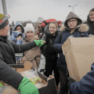 Volunteers give food and drinks to people, at the border crossing in Medyka, Poland, March 4