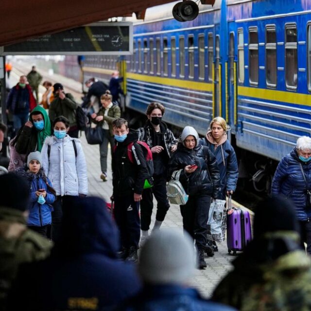 People fleeing the conflict in Ukraine arrive at Przemysl train station in Przemysl, Poland, on Friday, Feb. 25, 2022.