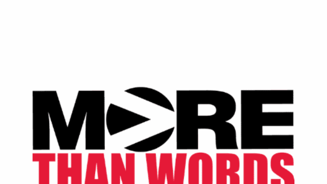 more than words logo: red and black text on a white background. A white greater than sign in inscribed in the 