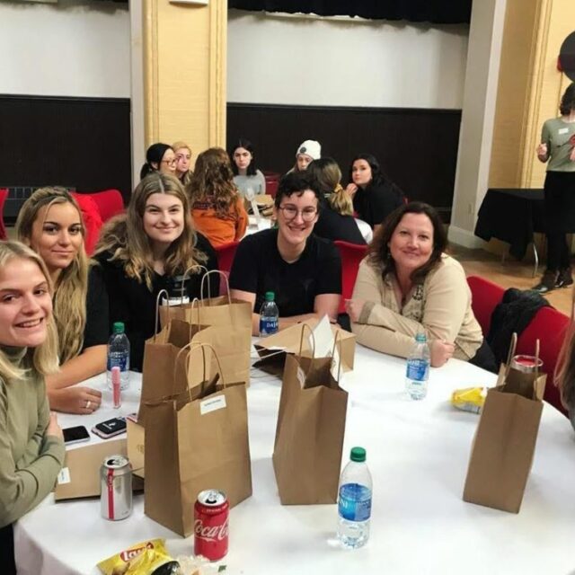 photograph of students eating lunch with Rebecca Riccio