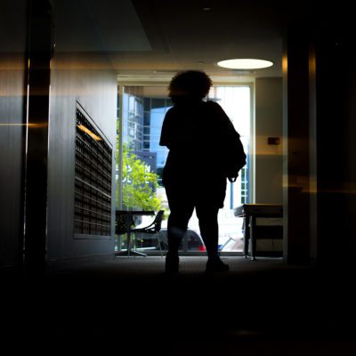 Human Services Minor Silhouette of person standing in a dimly lit hallway