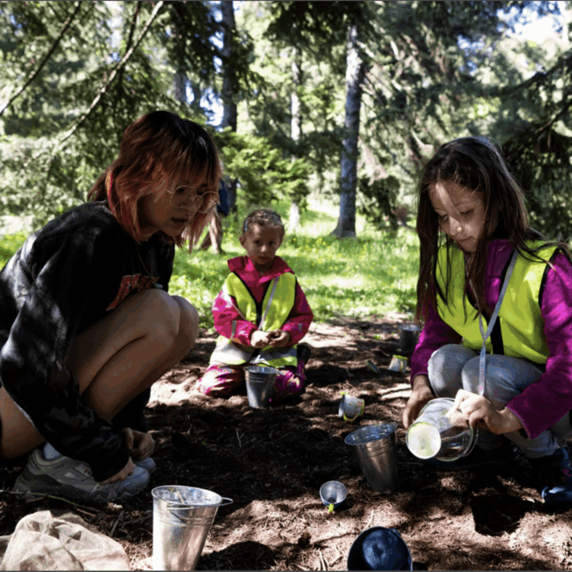 Fourth-year human services and international affairs graduate Ro Van Sloun plays with a child from the Boston Outdoor Preschool in the Arnold Arboretum in Boston
