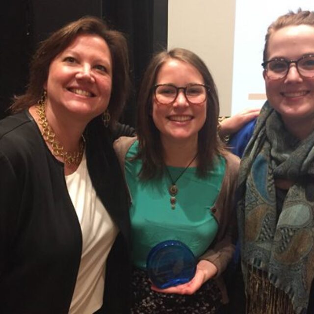 Left, Rebecca Riccio, founding director of the Social Impact Lab, Alexandra Fraenkel, and Rebecca Darling, holding the “Changemaker Campus” award presented to them at the Ashoka U Exchange last week.