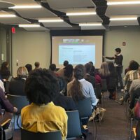Fall Celebration attendees watch a lightning talk presented by DSG-affiliated scholars