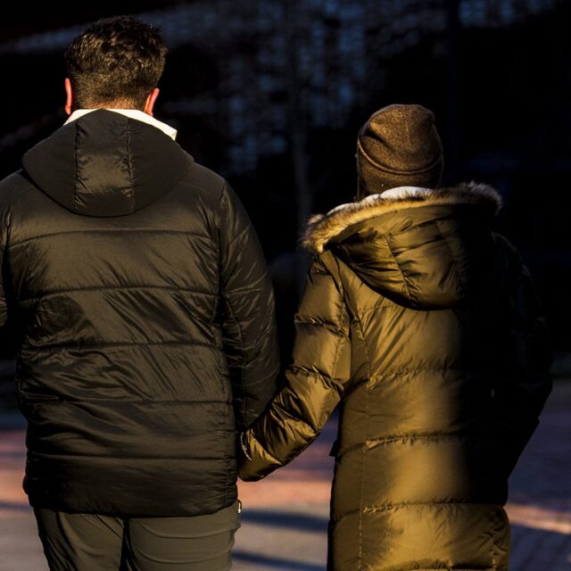 Members of the Northeastern campus walk by the Egan Research Center holding hands on Tuesday, Jan. 4, 2022.