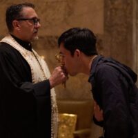 Man kisses cross in religious service