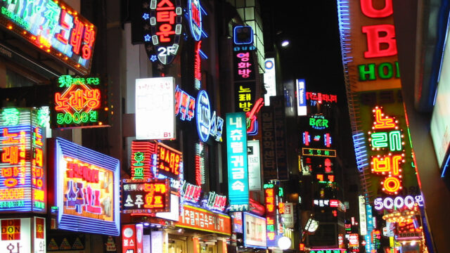 a cluster of colorful, bright neon signs at night in seoul, south korea