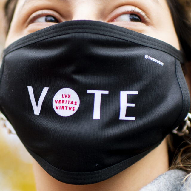 Ioanna Ploumi, who studies biology and political science, wears a Northeastern Votes face mask on Centennial Common on the day before Election Day.