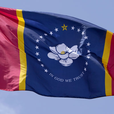 The magnolia centered banner chosen Wednesday, Sept. 2, 2020 by the Mississippi State Flag Commission flies outside the Old State Capitol Museum in downtown Jackson, Miss. The nine member committee voted to recommend a design with the state flower.