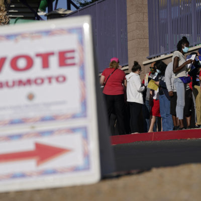 In this Nov. 3, 2020, file photo, people wait in line to vote at a polling place on Election Day in Las Vegas. The Nevada Supreme Court made Joe Biden's win in the state official on Tuesday, Nov. 24, 2020, approving the final canvass of the Nov. 3 election.