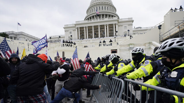 Trump supporters try to break through a police barrier, Wednesday, Jan. 6, 2021, at the Capitol in Washington.