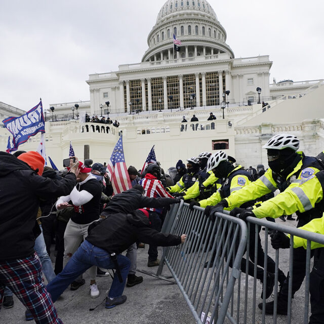 Trump supporters try to break through a police barrier, Wednesday, Jan. 6, 2021, at the Capitol in Washington.