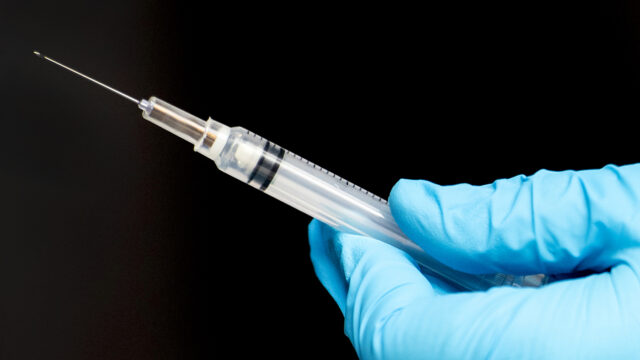 01/05/21 - BOSTON, MA: Nurse practitioner Jackie Fox prepares the Moderna COVID-19 vaccine to administrated at Northeastern’s testing center in Cabot Physical Education Center on Jan. 05, 2021.
