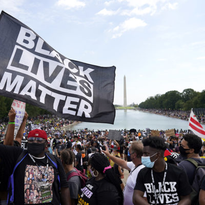 People attend the March on Washington, Friday Aug. 28, 2020, in Washington, on the 57th anniversary of the Rev. Martin Luther King Jr.'s 