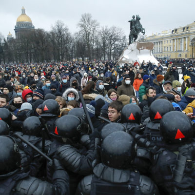 People clash with police during a protest against the jailing of opposition leader Alexei Navalny in St. Petersburg, Russia, Saturday, Jan. 23, 2021.