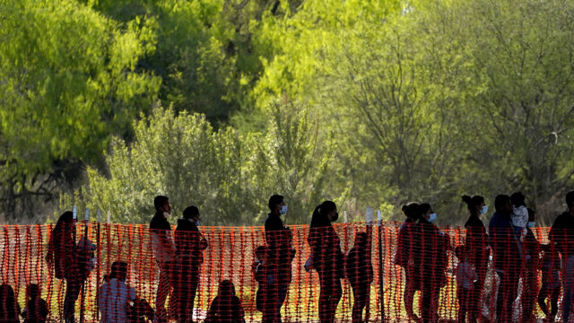 Migrants are seen in custody at a U.S. Customs and Border Protection processing area under the Anzalduas International Bridge, Friday, March 19, 2021, in Mission, Texas.