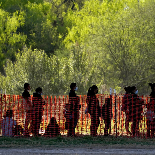 Migrants are seen in custody at a U.S. Customs and Border Protection processing area under the Anzalduas International Bridge, Friday, March 19, 2021, in Mission, Texas.