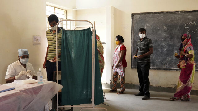 Indian People wait for verification on COWIN App for a dose of the Covishield Covid-19 coronavirus vaccine at a vaccination centre in Ajmer, Rajasthan, India on 07 May 2021.