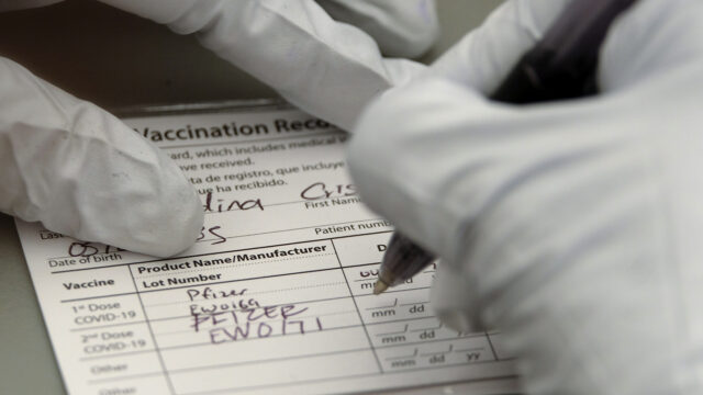 A nurse writes on a COVID-19 vaccination card at a vaccination site held by CHIRLA, the Coalition for Humane Immigrant Rights, and the Mexican Consulate, in Los Angeles, Saturday, May 8, 2021.