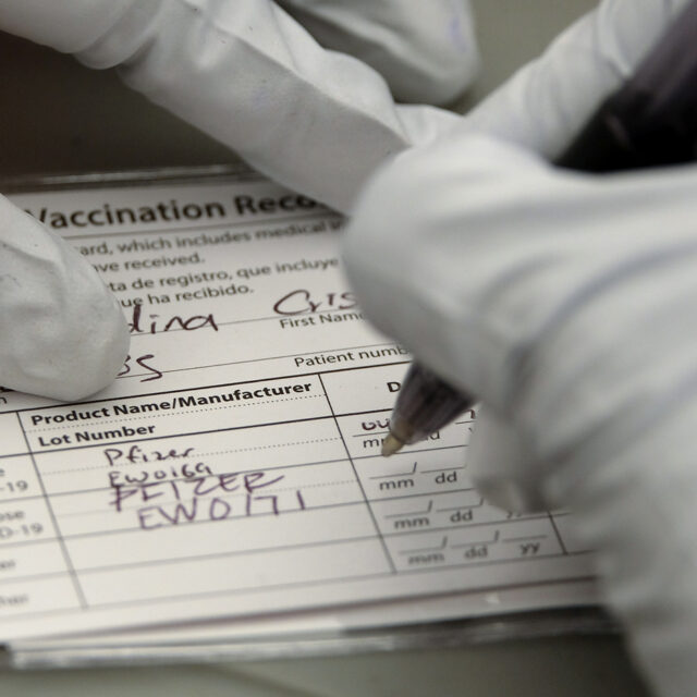 A nurse writes on a COVID-19 vaccination card at a vaccination site held by CHIRLA, the Coalition for Humane Immigrant Rights, and the Mexican Consulate, in Los Angeles, Saturday, May 8, 2021.
