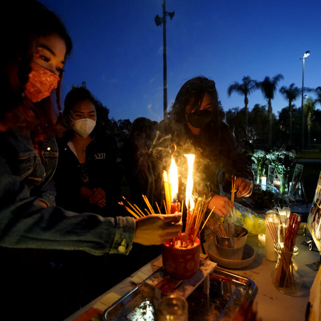 Women pay theirs respects at a memorial in honor of the victims of the shootings in Atlanta, where eight people were killed the week before, during a candle vigil in Monterrey Park, Calif., late Saturday, March 27, 2021. The shootings at three Georgia massage parlors and spas that left eight people dead, six of them women of Asian descent, come on the heels of a recent wave of attacks against Asian Americans since the coronavirus entered the United States. (AP Photo/Damian Dovarganes)