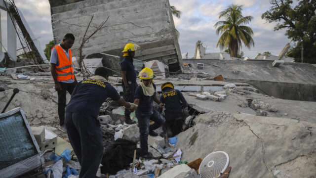 Firefighters search for survivors inside a collapsed building, after Saturday's 7.2 magnitude earthquake in Les Cayes, Haiti, Sunday, Aug. 15, 2021.