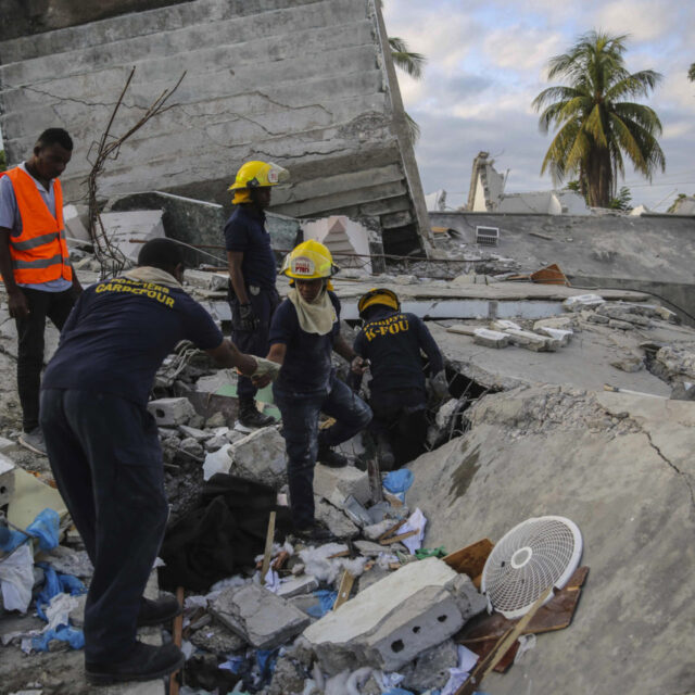 Firefighters search for survivors inside a collapsed building, after Saturday's 7.2 magnitude earthquake in Les Cayes, Haiti, Sunday, Aug. 15, 2021.
