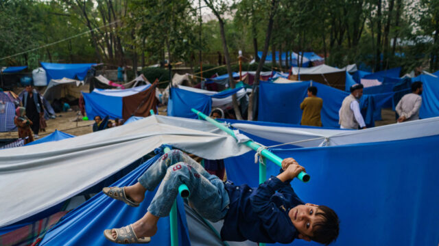 Afghan children pass the time making the most of their surroundings at a makeshift camp for displaced Afghans fleeing the fighting between the Taliban and the Afghan Security Forces at Hasa-e-Awal Park, in Kabul, Afghanistan, Saturday, Aug. 14, 2021.