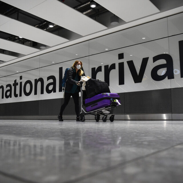 File photo dated 18/01/21 of a passenger pushing luggage through the Arrival Hall of Terminal 5 at London's Heathrow Airport.