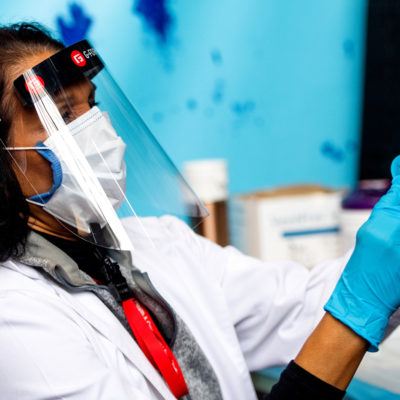 Nurse practitioner Shashi Narayan Uhlmann prepares to administer the Moderna COVID-19 vaccine to CTC staff member, Mukul Agrawal who studies construction management at Northeastern’s Cabot Testing Center on Jan. 06, 2021.