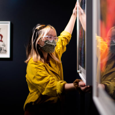 Megan Lam, who studies architecture design and Gallery Manager, installs a new Gallery 360 exhibit titled 