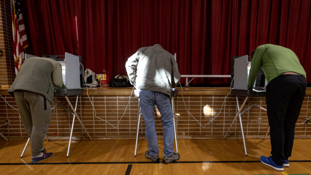 People cast their vote at the Kenny Elementary School on Tuesday, Nov. 2, 2021 in Minneapolis. Voters in Minneapolis are deciding whether to replace the city's police department with a new Department of Public Safety. The election comes more than a year after George Floyd's death launched a movement to defund or abolish police across the country.