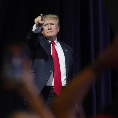 Former President Donald Trump points to supporters after speaking at a Turning Point Action gathering, Saturday, July 24, 2021, in Phoenix.