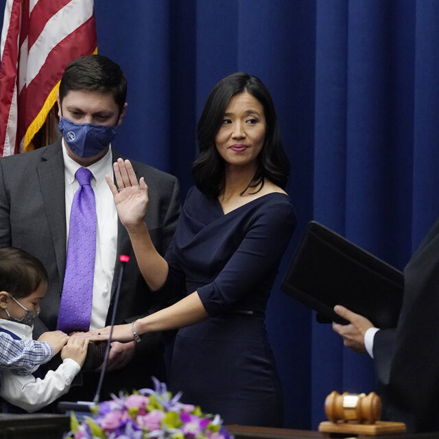Michelle Wu raises her hand as she is sworn-in as Boston Mayor during a ceremony at Boston City Hall, Tuesday, Nov. 16, 2021, in Boston.