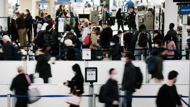 Travelers arrive for flights at Newark Liberty International Airport on November 30, 2021 in Newark, New Jersey.