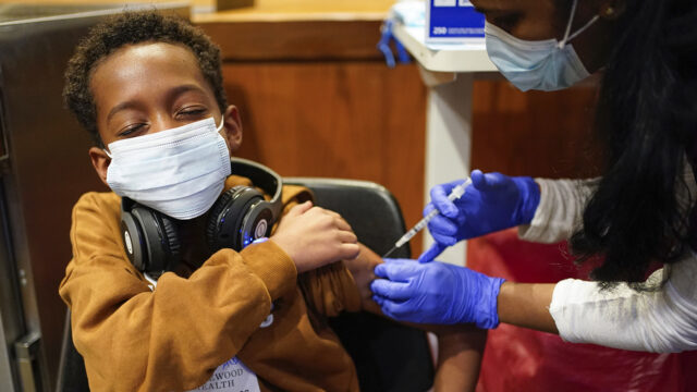 Cameron West, 9, receives a COVID-19 vaccination at Englewood Health in Englewood, N.J., Monday, Nov. 8, 2021.