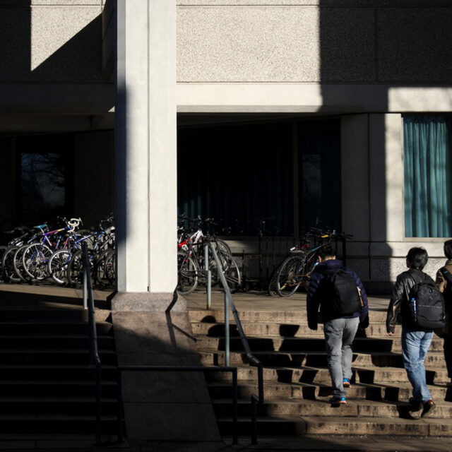 Students walks through a patch of light outside of Snell Library on Jan. 28, 2016.