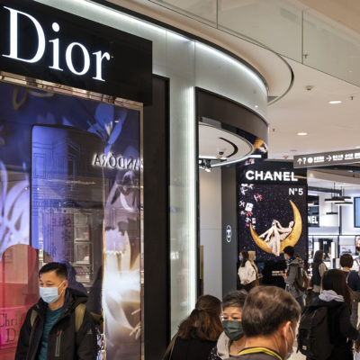 Shoppers walk past the French Christian Dior luxury goods, clothing and beauty products store seen in Hong Kong.