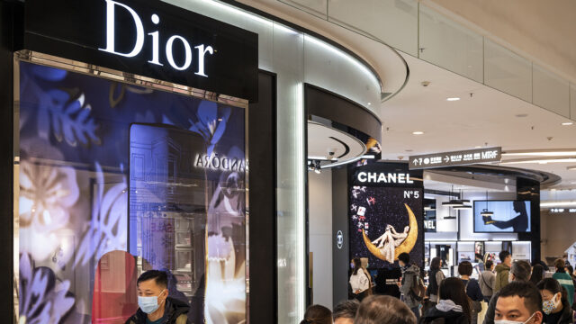 Shoppers walk past the French Christian Dior luxury goods, clothing and beauty products store seen in Hong Kong.