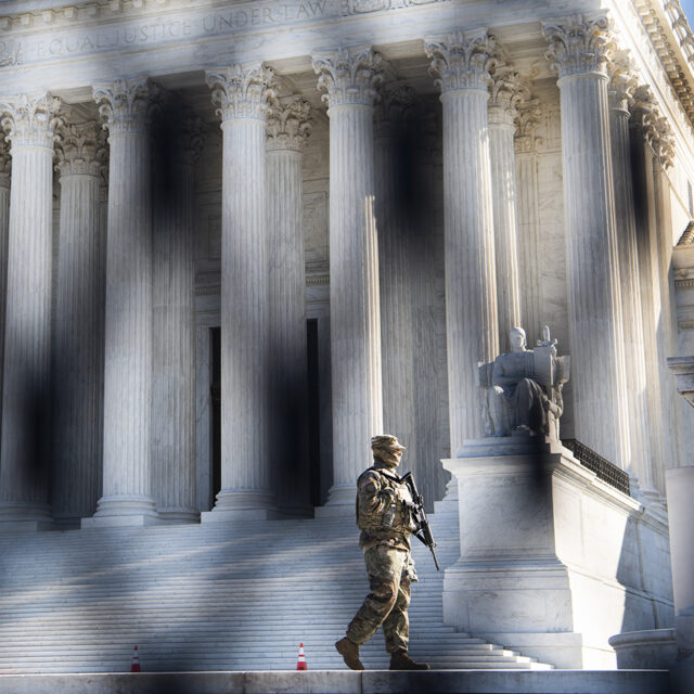 A member of the National Guard patrols the steps of the Supreme Court on Monday, February 8, 2021.