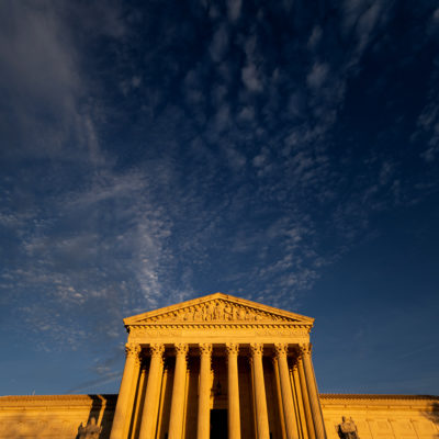 Sunset light illuminates the U.S. Supreme Court building on Tuesday, Dec. 7, 2021.