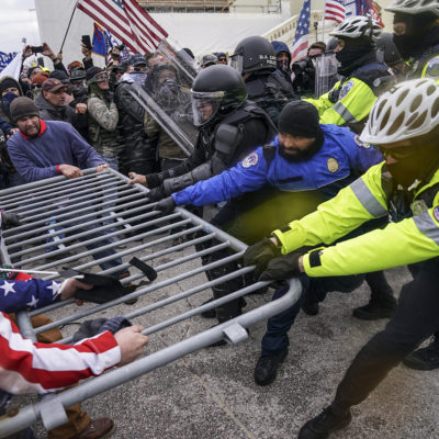 In this Jan. 6, 2021, file photo rioters try to break through a police barrier at the Capitol in Washington.