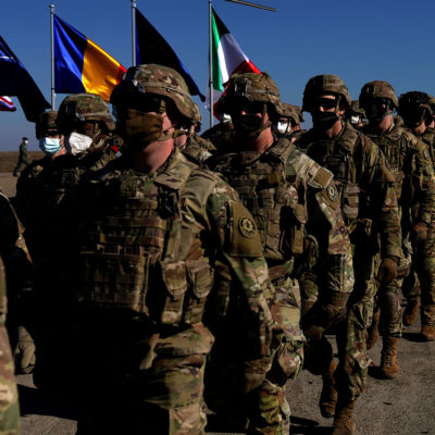 US soldiers march after a visit by NATO Secretary General Jens Stoltenberg, on February 11, 2022 in Mihail Kogalniceanu, Romania.