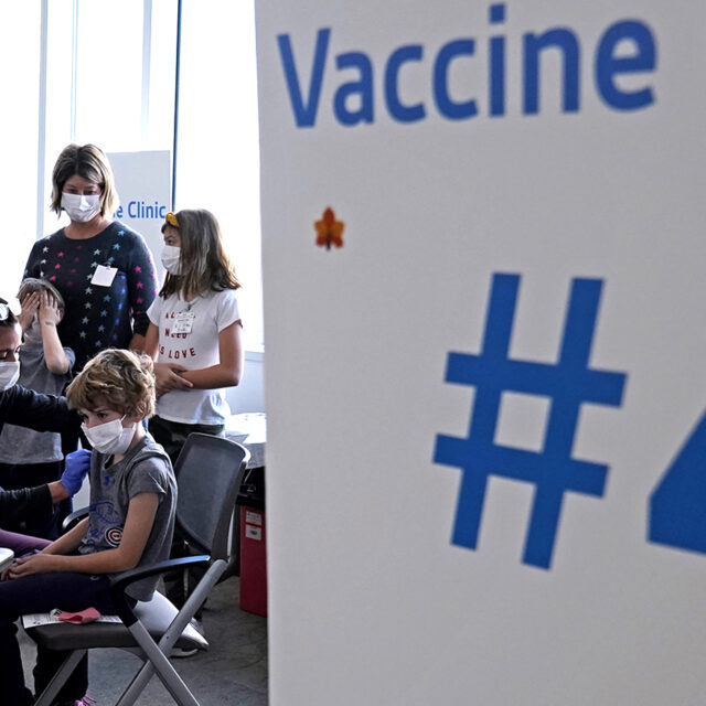 Graham Roark, 8, receives the Pfizer COVID-19 vaccine for children 5 to 11 years from Lurie Children's hospital registered nurse Virginia Scheffler at the hospital Nov. 5, 2021, in Chicago.