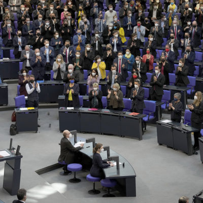 Lawmaker applaude during German Chancellor Olaf Scholz' speech on the Russian invasion of the Ukraine during a meeting of the German federal parliament, Bundestag, at the Reichstag building in Berlin, Germany, Feb. 27, 2022.